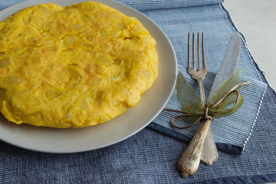 spanish omelette called tortilla de patatas with vintage cutlery