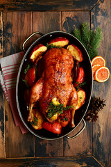 Roast goose stuffed with baked apples in a skillet, festive christmas recipe. Top view with copy...