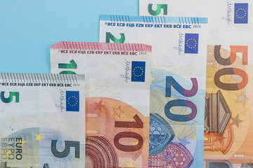 Euro currency cash bank notes money blue background