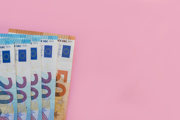 Euro currency cash bank notes money pink background
