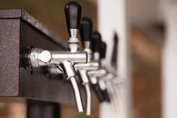 Modern beer taps in a row