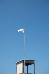 Milano Marittima, Italy -  August 06, 2019 : View of a life guard tower and a white flag