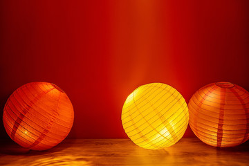 Beautiful retro colored paper lanterns hanging on a red background