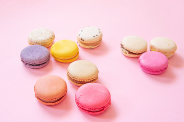 Fototapeta na wymiar French colorful macaroons cakes flat lay. Small sweet biscuits isolated on pink background. Dessert. Happy bithday and valentine’s day creative minimal concept. Confectionery. Bakery design element.