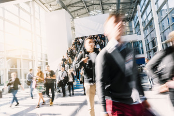 blurred business people at a trade fair