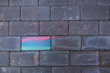 Fototapeta premium Paving stones painted with colored chalk. Multi-colored stone.