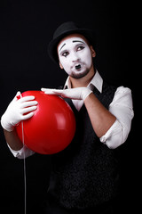 mime shows theatrical emotions on black background