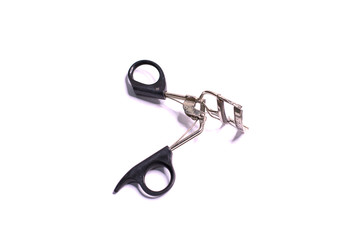 The eyelash curler is used with a black handle.