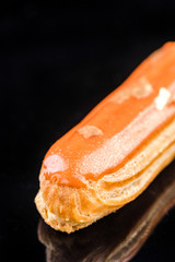 French Artisan Eclair on Black Reflective Background,Copy Space