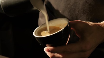 Barista making of cafe latte art, heart shape. Making Cappuchino in Coffeeshop