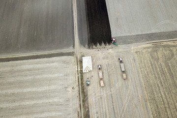Areal view of agriculture  machines and bales of hay