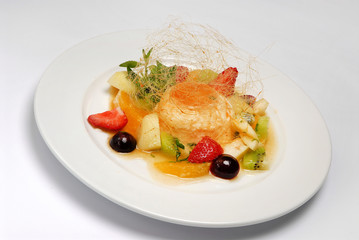 Fresh fruit and vanilla ice cream with caramel decor close up