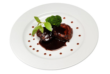 Delicious grilled meat thigh on white plate with soy sauce in center of dish, view from above,...