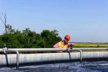 Worker inspecting valve during filtration