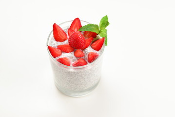 Chia pudding with strawberry and mint on a white background. Space for text or design.