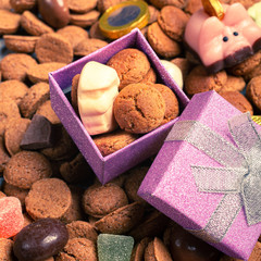 Beautiful St. Nicholas Day Greeting Card. Dutch holiday Sinterklaas background with gift and pepernoten. Children's party concept with copy space.