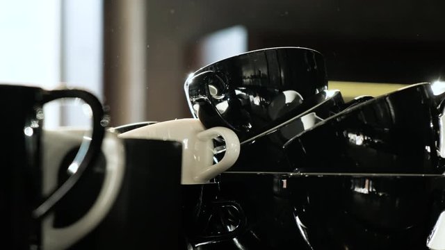 Black ceramic cups on coffeemachine. Morning in coffeeshop.