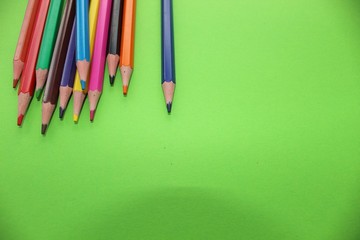 Drawings with colored pencils on a green background