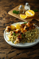 Homemade chicken skewers with bulgur and herbs