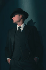 Fototapeta na wymiar Retro man in hat wears suit and tie.