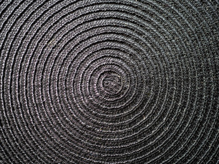Fototapeta premium Black abstract woven surface with spiral circles
