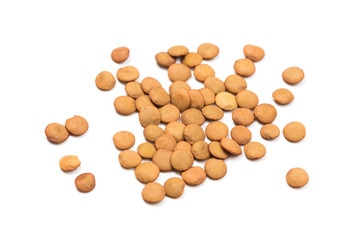 Isolated stack of uncooked lentils on white background from above.