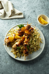 Homemade chicken skewers with bulgur and herbs