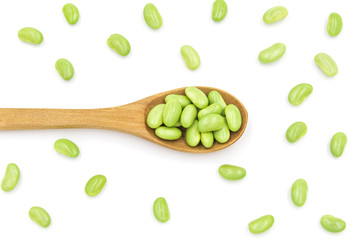 Top view of creative food patterns with green soybeans and wooden spoons
