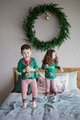 Cute children brother and sister elves, Santa's little helpers with a Christmas magic gifts
