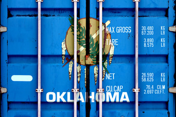 The national flag of the US state Oklahoma in a container doors on the day of independence in...