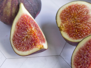 ripe figs with a knife on a marble table