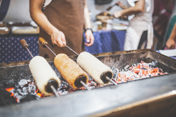 Chimney cake preparation. Chimney cake is being roasted over the fire. Street food concept.