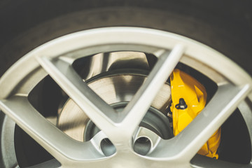 Close up of a modern sport wheel with yellow brake