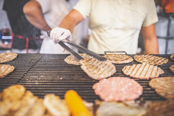 Street food barbecue burger preparation. Fast food concept.