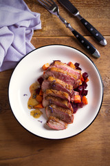 Sliced duck breast fillet with sweet potatoes and  beetroot on plate