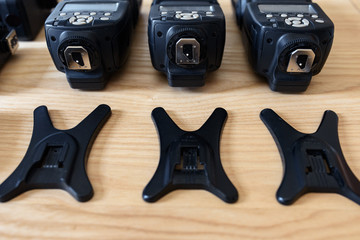 Equipment professional photographer on a wooden background. Camera, lenses, flashes, light filters.