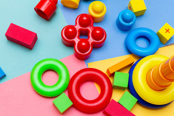 Fototapeta premium Colorful child kid’s education toys pattern background on the bright background. Childhood infancy children babies concept.