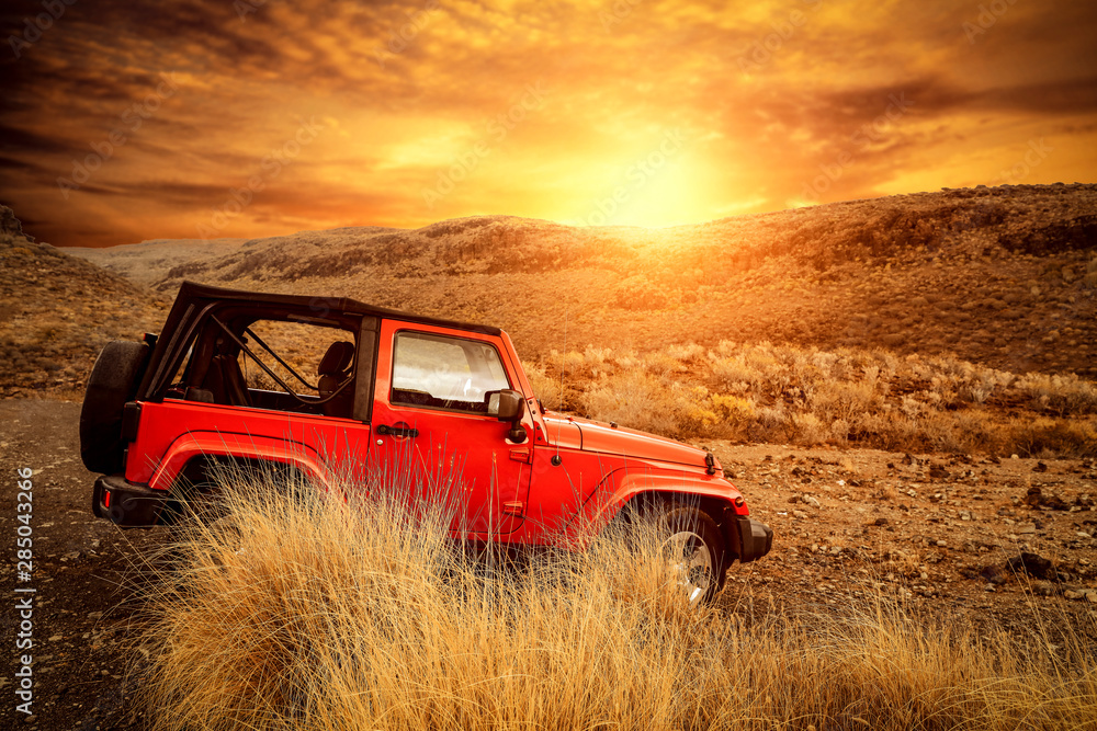 Wall mural red big autumn car and mountains landscape.