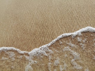 Top view of sandy beach. Background with copy space and visible sand texture.