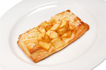 Buns with apples and cinnamon on plate on a white isolated background