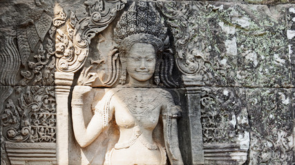 Bas reliefs depicting the beautiful Apsara deva on the wall at Angkor Wat Temple built in the 12th century in the ancient city, Siem Reap, Cambodia.