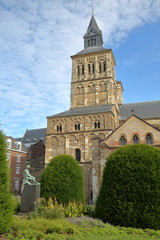 The basilica of Saint Servatius with the bronze statue of Hendrik van Veldeke (created by Charles...