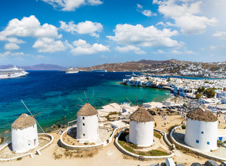 Die berühmten, traditionellen Windmühlen über der Stadt von Mykonos, Kykladen, Griechenland - obrazy, fototapety, plakaty