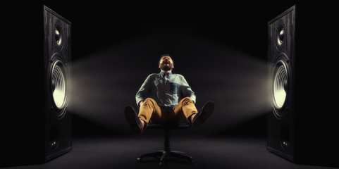The powerful sound tossing a man in air. Concept of power sound.