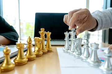 Businessman play chess on the marketing work place