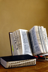 Holy Bibles on a table and eyeglasses