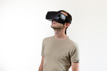 Man exploring modern technology virtual reality with head mounted display on white background