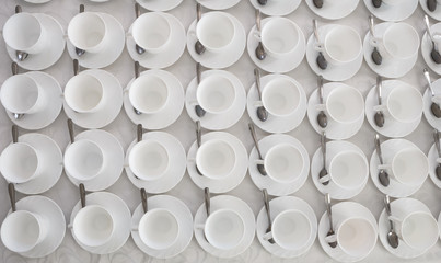 empty white coffee tea cups in rows on the table