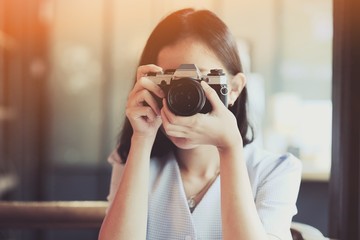 Asian girl taking photo by  SLR Film camera