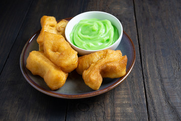 Chinese deep fried dough sticks and Pandan Custard on wood table.